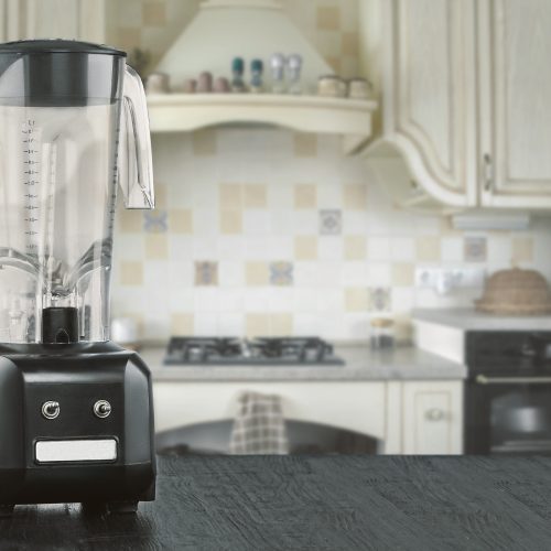 Blender and wooden table in kitchen. Do Smoothies